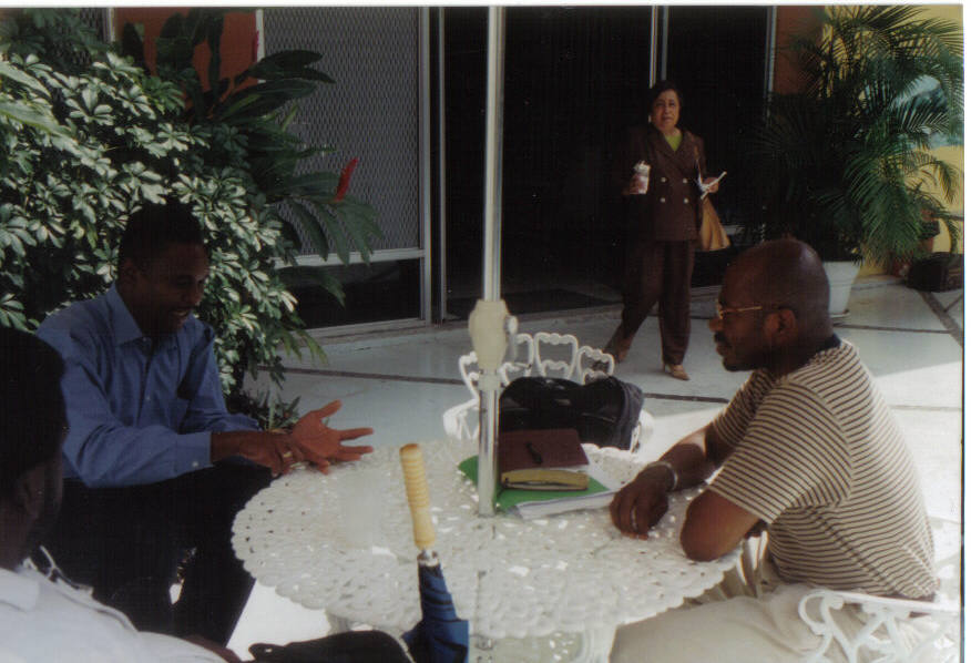 Gustavo Makanaky of Colombia meets with another representative in the courtyard.